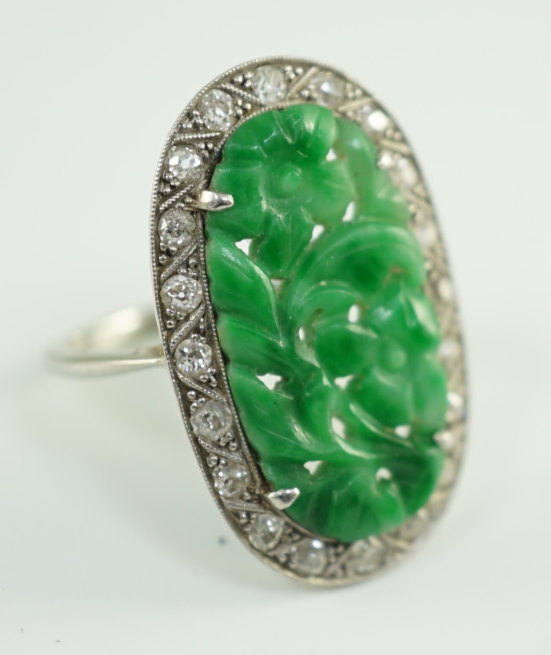 A 1920's/1930's white gold, jadeite and diamond set oval dress ring